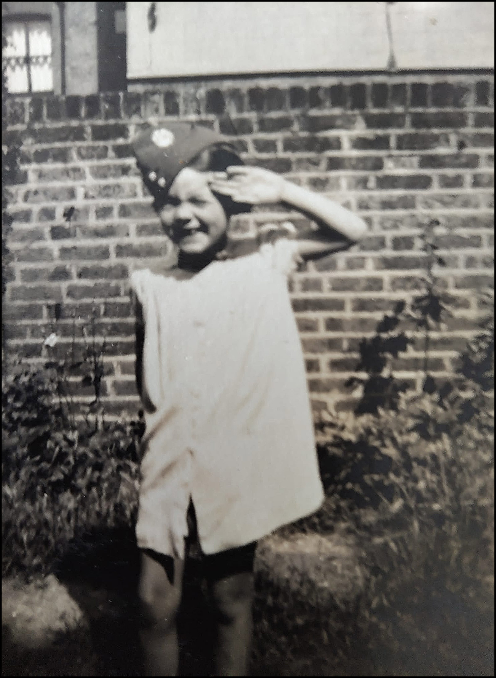 Janet Betterton saluting, probably in the garden at West Side, Wandsworth Common, c.1940