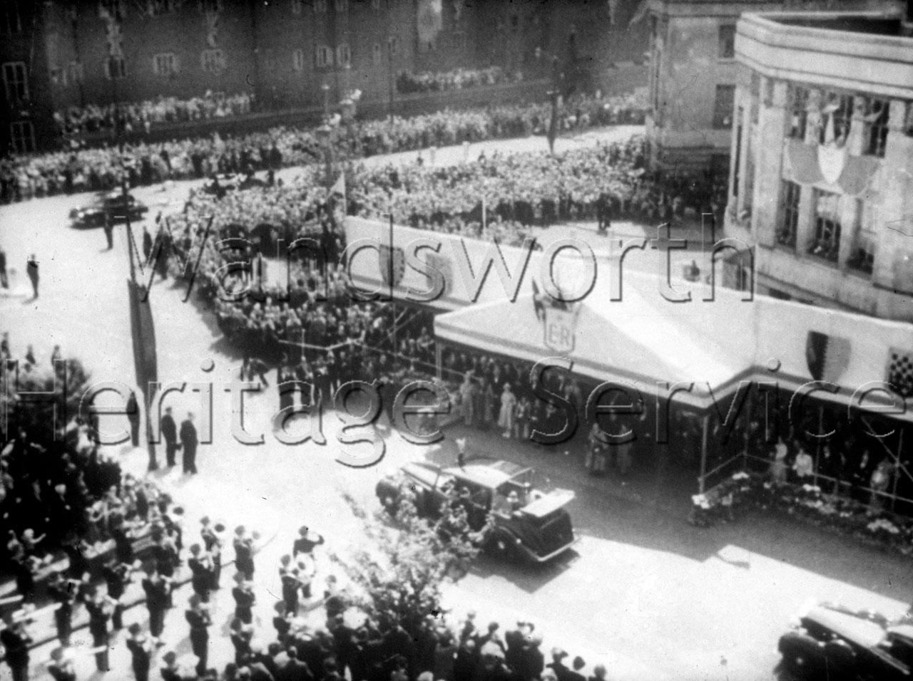 Aerial view of crowds and motorcade at Wandsworth Town Hall, 9 June 1953